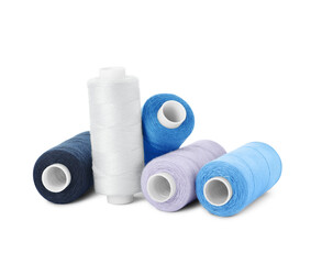 Many different colorful sewing threads on white background