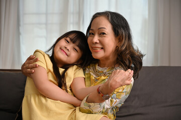 Portrait image of Grandmother and granddaughter are embracing each other in love.