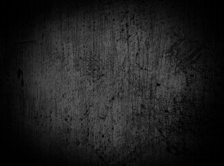 Black rough cement wall surface. The plastered concrete texture has scratches and dark cracks. The background is full of grainy vignettes. Empty space for design.