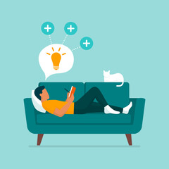 Man lying on the couch and writing