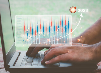 2023 business finance technology and investment concept. Businessman or trader is showing a growing virtual hologram stock, invest in trading. planning and strategy, progress or success concept.