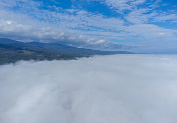 Fototapeta na wymiar Landscape above a layer of fog