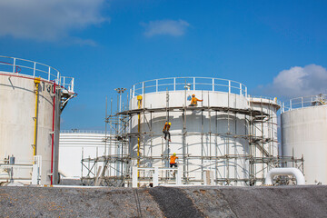 Worker male assembly in progress storage new tank  oil inspection scaffolding .