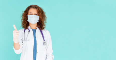 Covid19, coronavirus, healthcare and doctors concept. Portrait of optimistic caucasian female doctor assure everything be okay, thumb-up, wear medical mask to prevent catching virus, white coat