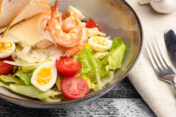 Caesar salad, caesar with shrimp salad on a white background, side view