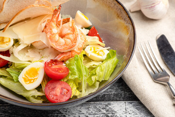 Caesar salad, caesar with shrimp salad on a white background, side view