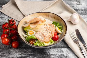 Caesar salad, caesar with chicken salad on a white background, side view