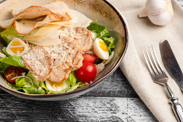 Caesar salad, caesar with chicken salad on a white background, side view