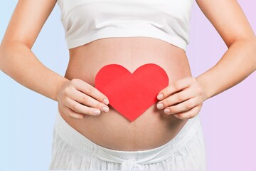 Young woman with hands on her belly. Concept of pregnancy