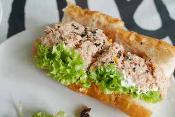 Tuna sandwich with mayonnaise on a plate on table 