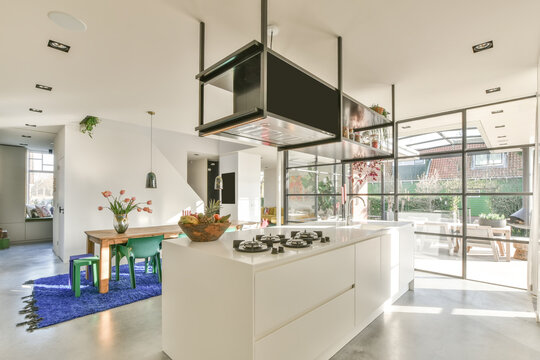 Interior of modern spacious kitchen with island counter