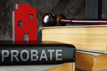 Probate law book and model of house on it.