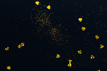 Fototapeta premium Dark blue background with golden glitter and hearts confetti