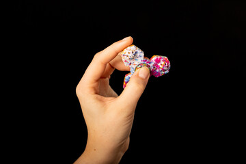 Child's hand playing with a fidget spinner toy