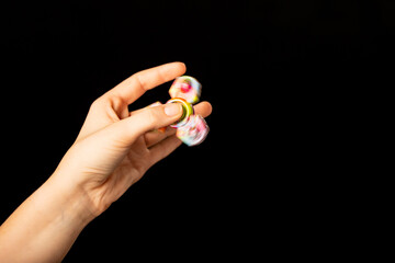 Child's hand playing with a fidget spinner toy