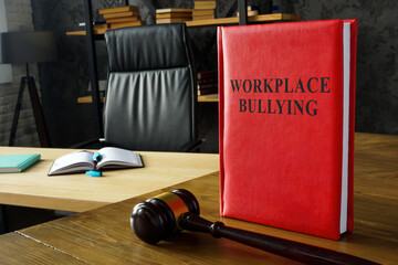 Rules about workplace bullying and gavel on the wooden surface.