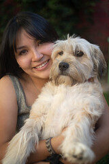 young woman hugging her puppy
