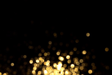 Golden blurred bokeh lights on black background. Glitter sparkle stars for celebrate. Overlay for your design