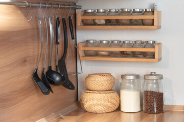 kitchen interior with cutlery and a set of spices, glass jars for storing spices, cereals, sugar, eco friendly, order in the kitchen