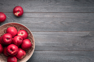 red ripe apples on a wooden background, apple harvest, free space for text, top view