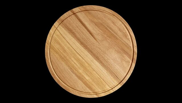 Wooden round pizza stand or cutting board isolated on black background, rotating, turning, close-up macro, top view.

