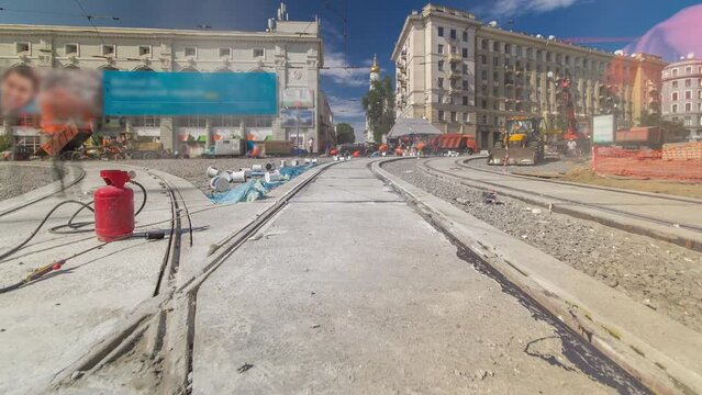 Tram rails at the final stage of their installation and integration into concrete plates on the road panoramic timelapse. Filling by liquid resin for reduction of vibration and noice. The process of
