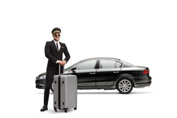 Full length profile shot of a chauffeur standing in front of a black car with a suitcase