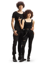 Full length portrait of a trendy young couple in black clothes gesturing rock and roll sign