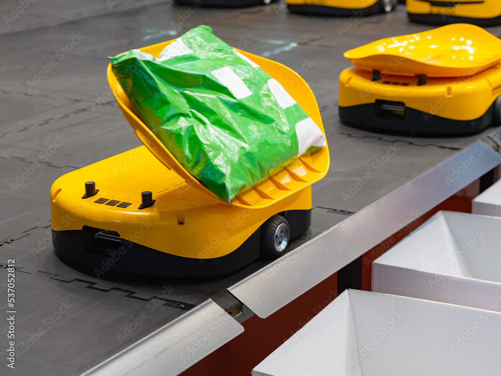Poster warehouse robot sorter. miniature yellow robot for moving goods to storage location. warehouse robot