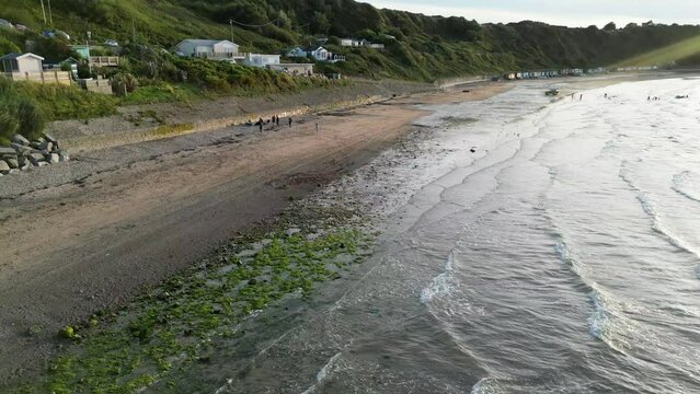 Aerial shot of the wavy Nefyn beach at a sunset