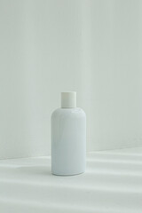 Front view of empty plastic cosmetics bottle isolated on white