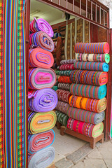 Stacks of Amazing Multi-colored Peruvian fabric rolls for sale in downtown Cuzco, Peru, South America