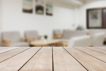 Empty old wood table in front of blurred sofa in the living room looks clean and decorated in comfortable tones, suitable for relaxation. Can be used for display or montage for show your products.