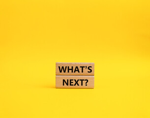 What is next symbol. Concept word What is next on wooden blocks. Beautiful orange background. Business and What is next concept. Copy space