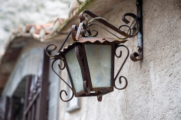 Antique street lamp on the wall of the house