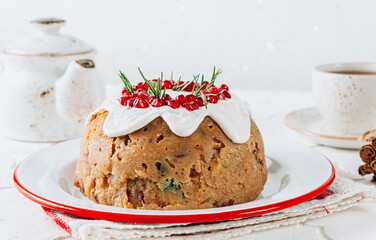 Traditional Christmas fruit pudding on white festive background.