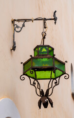 Antique street lamp on the wall of the house