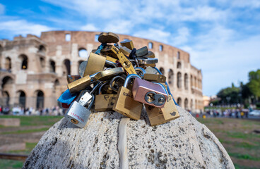 Love locks on the background of the Colosseum