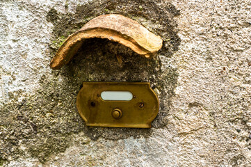 Vintage bell button on an old wall