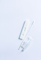 covid 19 test kit on white background,Top view or flat lay of Covid-19 negative test result antigen test kit ATK with a nasal swab on white background with copy space. Antigen test kit for self collec