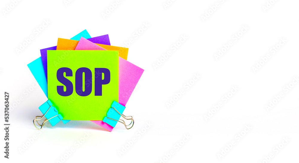 Poster there are bright multi-colored stickers with the text sop standard operating procedure. copy space