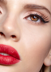 Fototapeta premium Closeup shot of human female face with pink eyes makeup and red lips