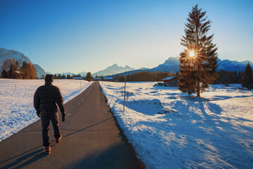 hiker at Buckelwiesen route, beautiful winter landscape on the way to Mittenwald, upper bavaria