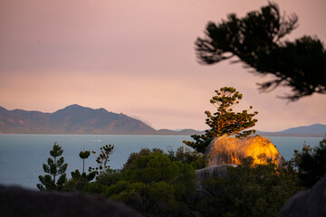 panorama of magnetic island at sunset, colourful sunset over paradise beaches on magnetic island;...