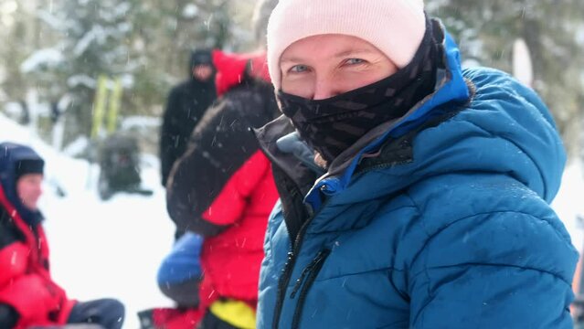 A girl looks slyly during a winter hike. The girl turns and tries to consider what distracted and alerted her.