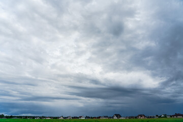 Photo of the clear blue sky with white clouds above countryside