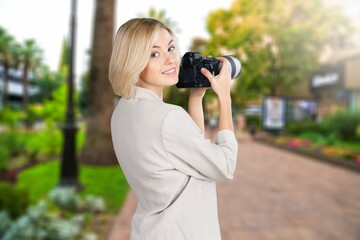Tourist woman enjoying beautiful view with camera