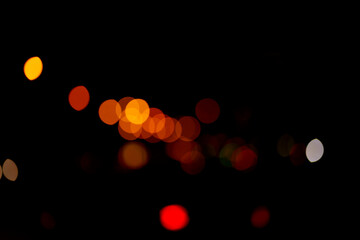 Isolated black background of blurred bokeh with warm red lights. With a space to copy, overlay for your design. High quality photo