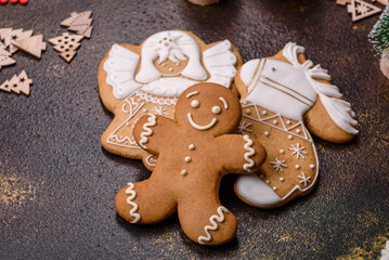 Beautiful gingerbread on a brown ceramic plate with Christmas tree decorations