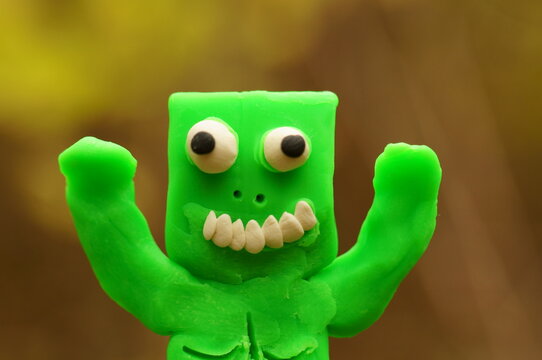 Funny monster made of green plasticine.